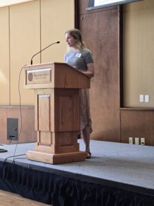 Laura Bates presents at a podium