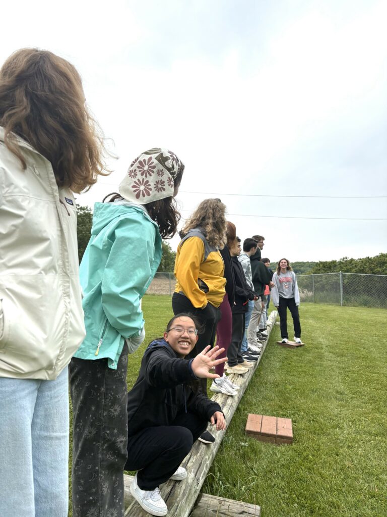 Students puzzle through a low ropes course
