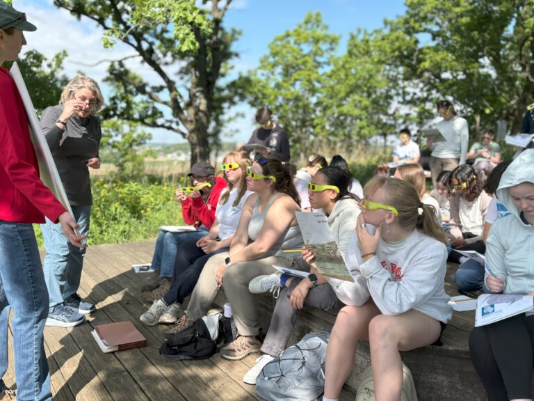 A group of students with 3D glasses, learning about watersheds