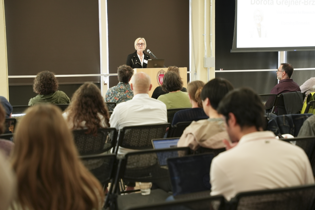 Woman speaks to audience behind podium