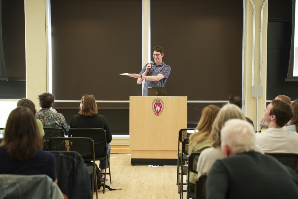 man addresses audience