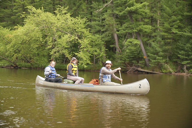 Researchers travelling by canoe on a river